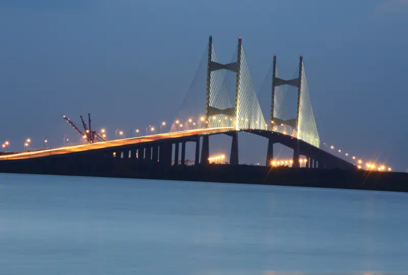 The Dames Point Bridge lit up over the St. Johns River at dusk