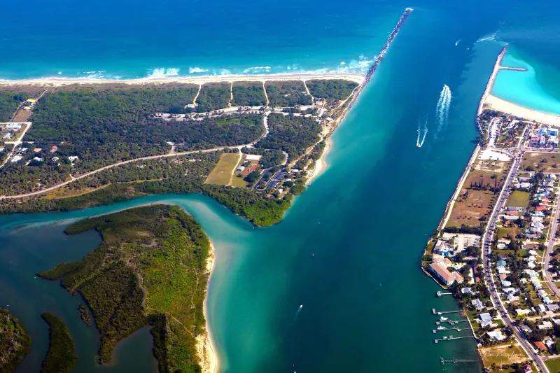 Aerial view of the Fort Pierce Inlet, its jetties and turquoise water meeting the ocean